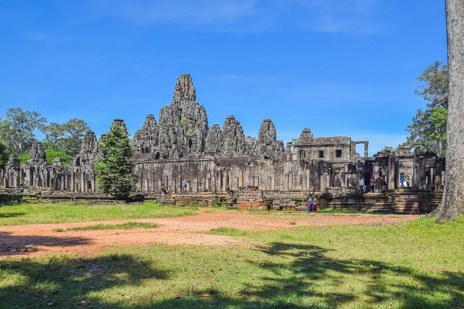 The towers of the Bayon temple at Angkor Thom under a blue sky