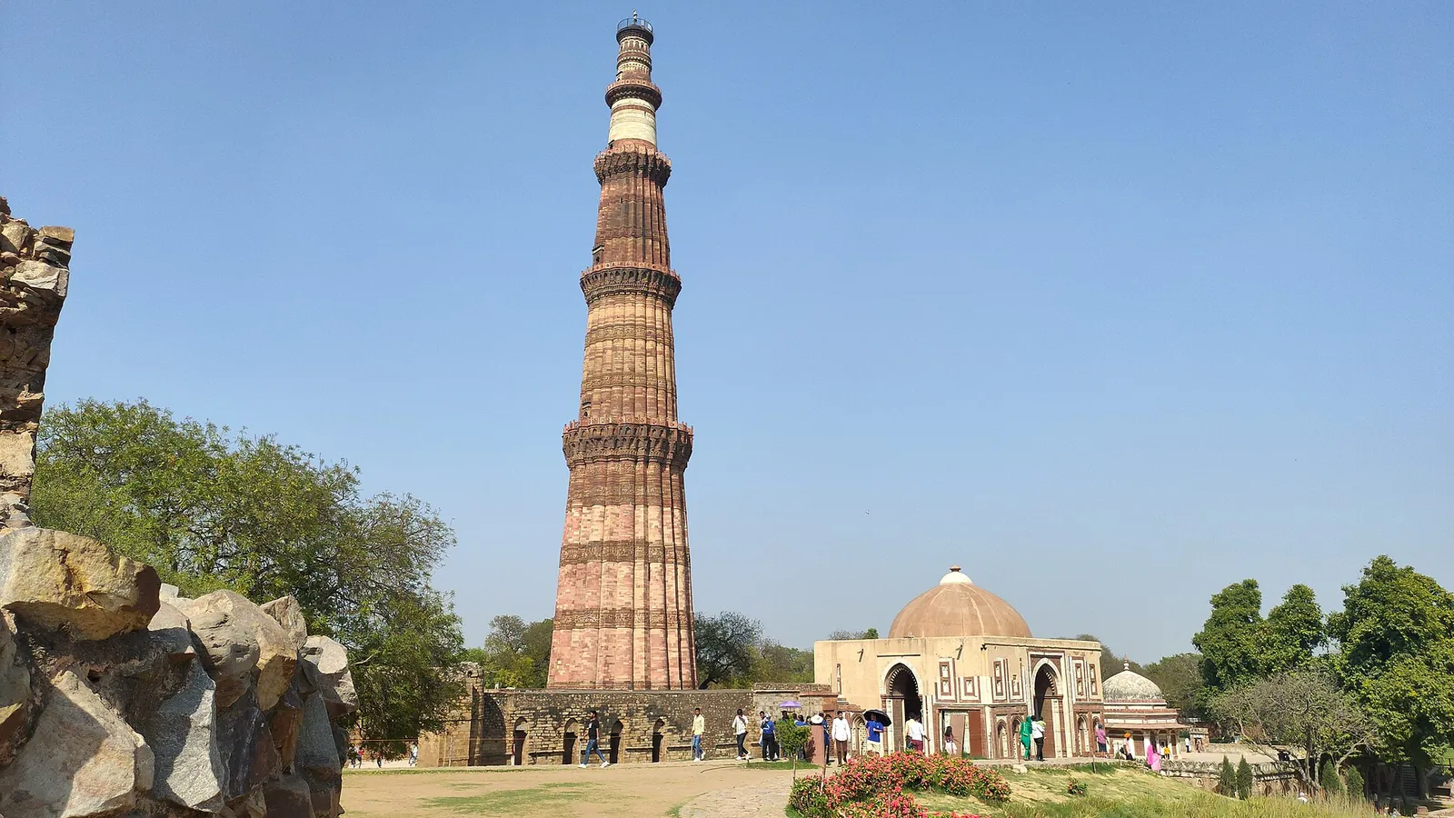 Der Qutb Minar erhebt sich über dem Alai Darwaza und den Gärten des Qutb-Komplexes