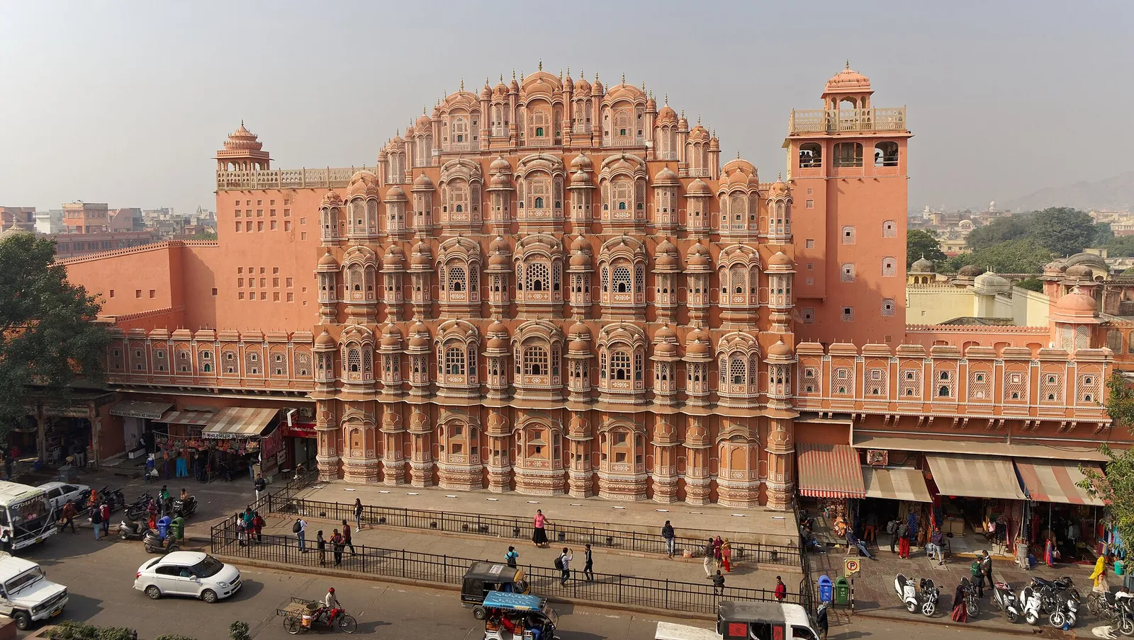 The pink sandstone screen of Hawa Mahal above a Jaipur street