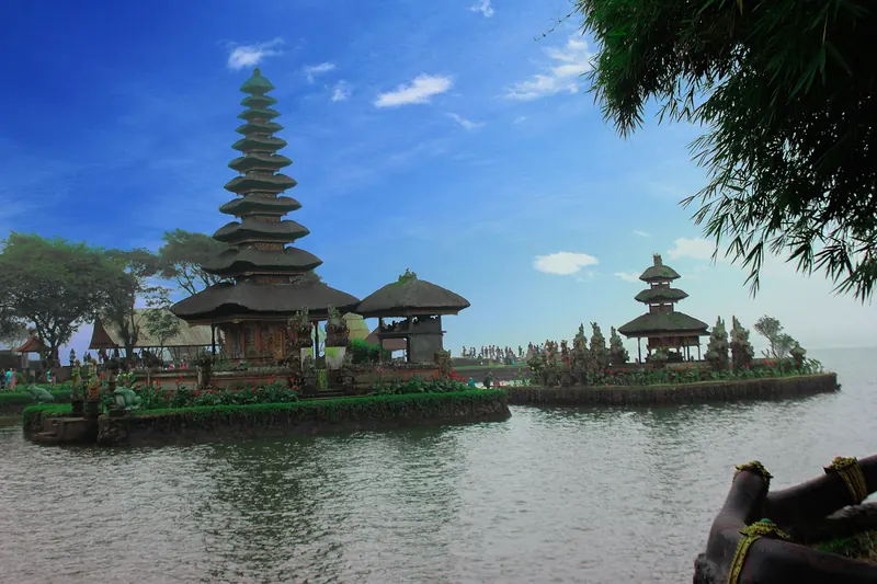 Tiered meru shrines of Pura Ulun Danu Beratan at the edge of Lake Beratan under a blue sky