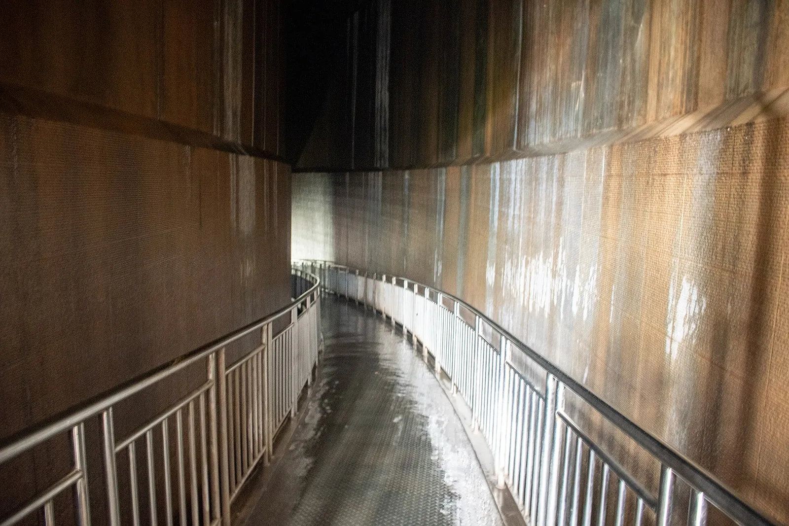 Dim, narrow corridor with high dark walls at the entrance of the Aceh Tsunami Museum