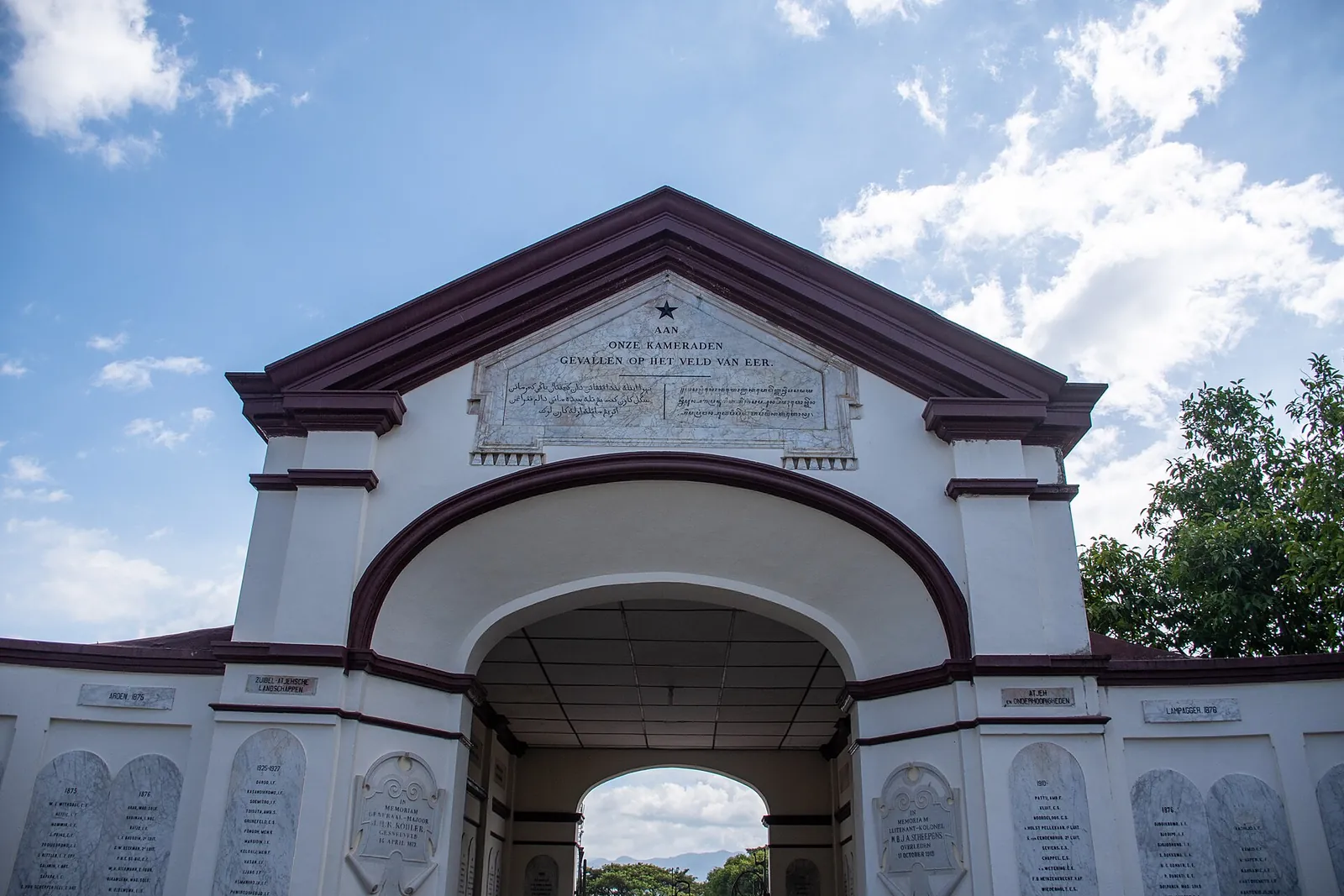 White arched gateway of the Kerkhof Peucut Dutch military cemetery in Banda Aceh