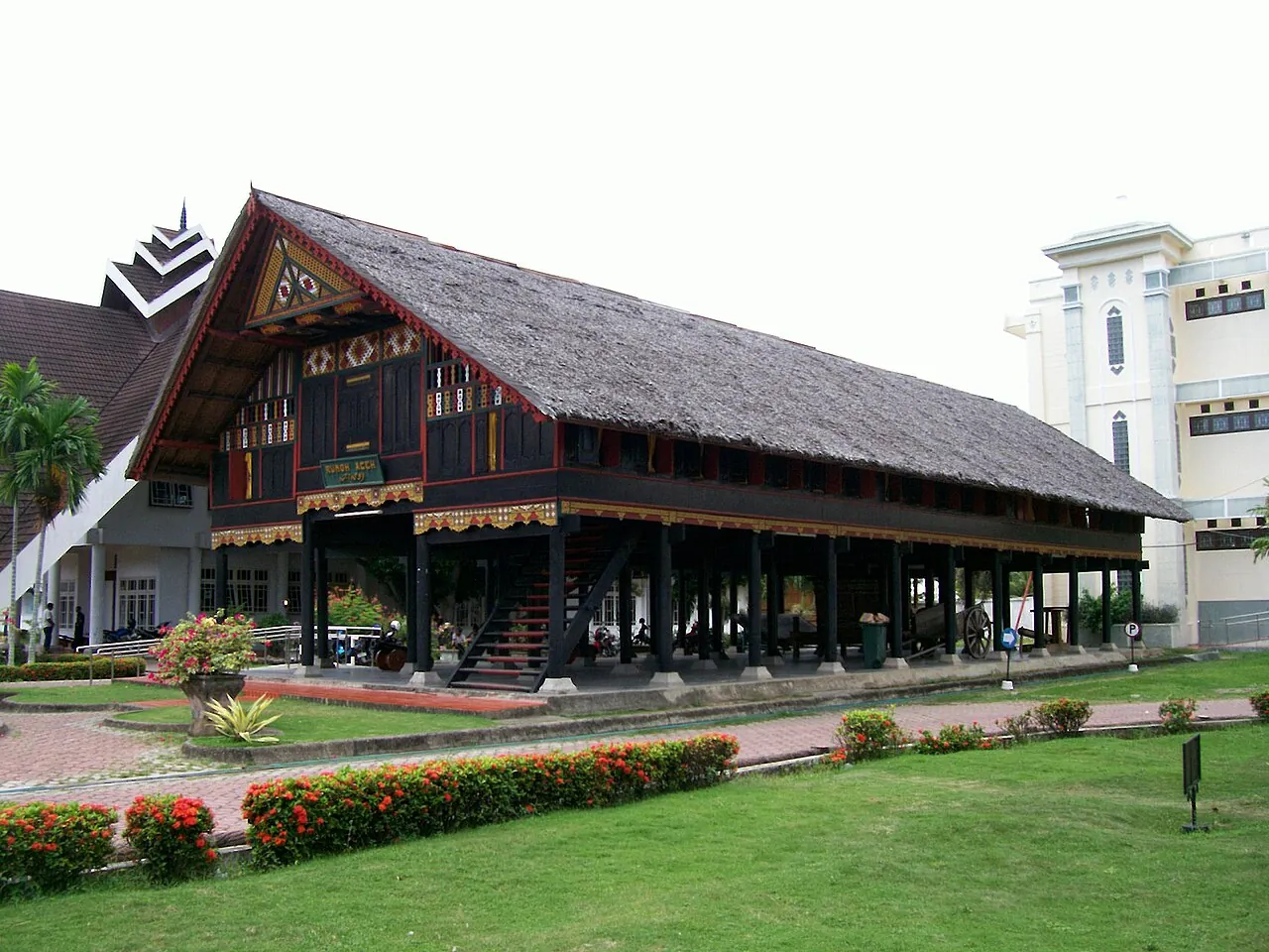 Rumoh Aceh, a wooden traditional Acehnese stilt house with a thatched roof, in the grounds of Museum Aceh