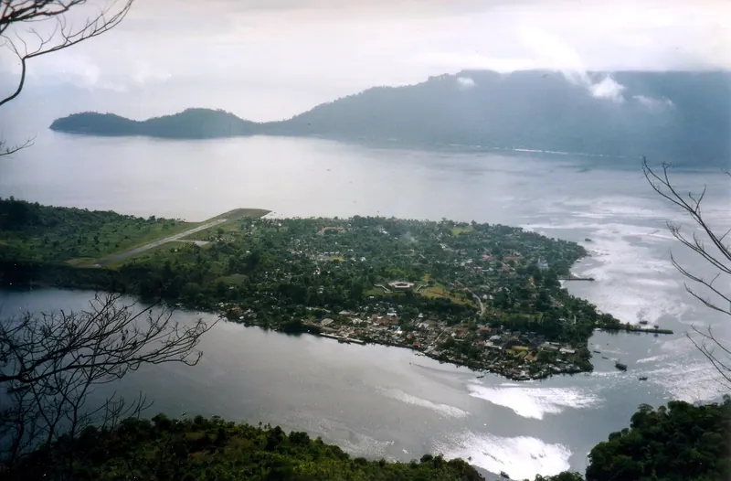 The town of Banda Neira and its airstrip seen from the slopes of Gunung Api, with Banda Besar across the water
