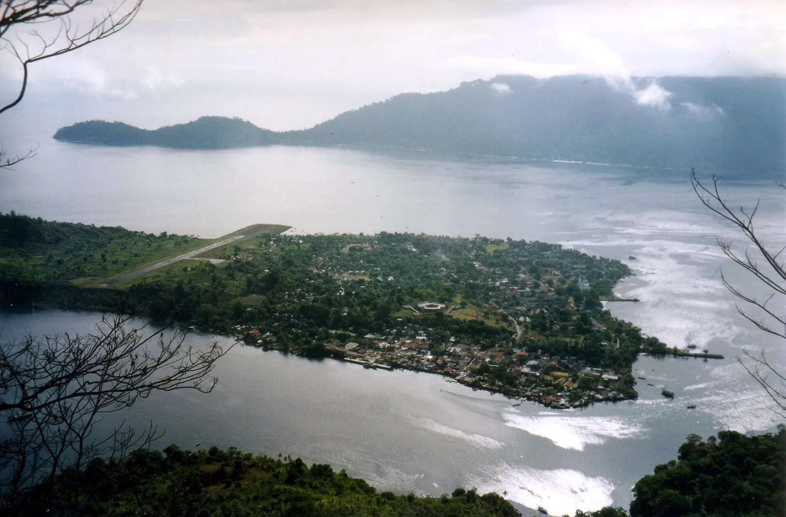 The town of Banda Neira and its airstrip seen from the slopes of Gunung Api, with Banda Besar across the water