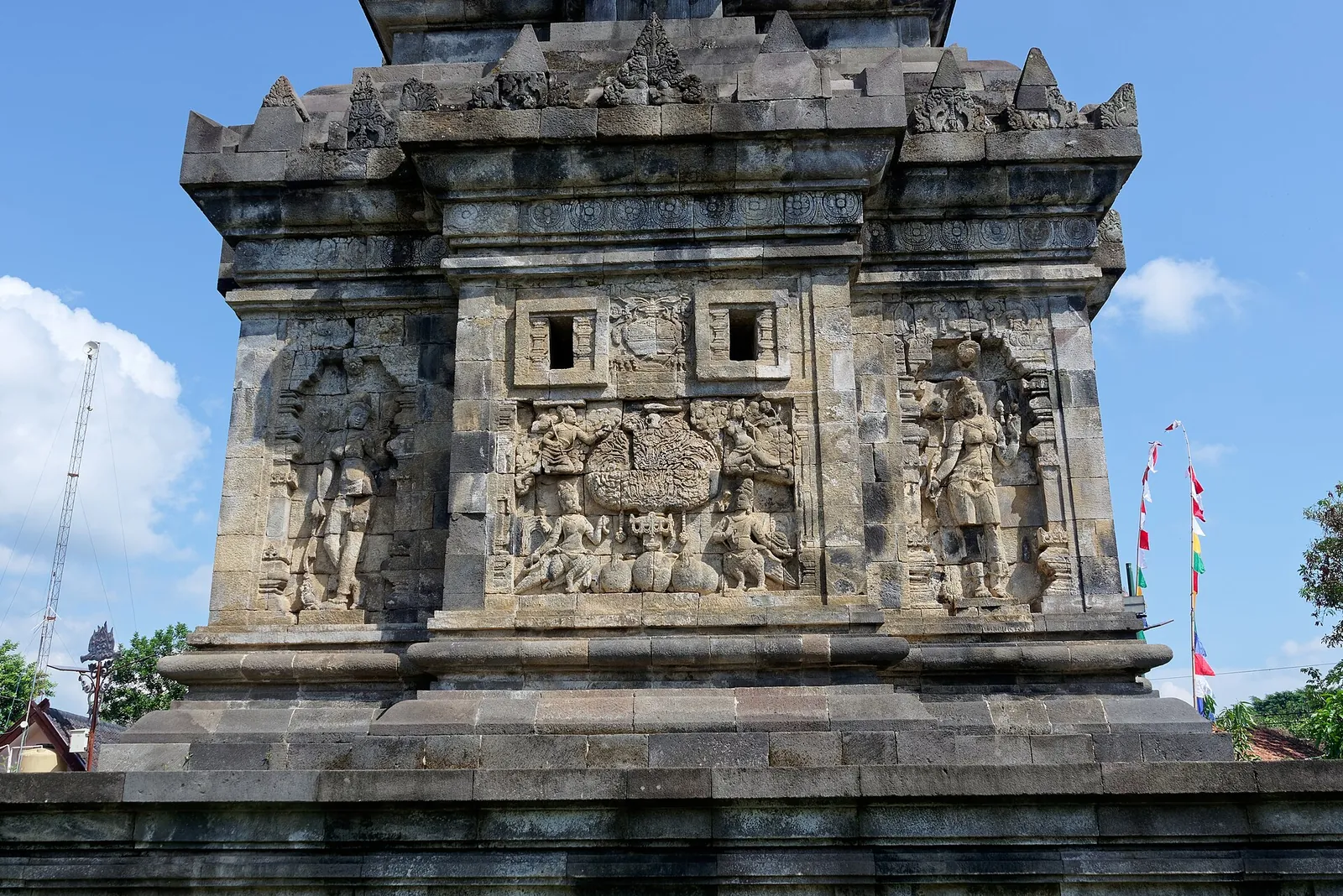 Carved reliefs on the walls of the small stone temple of Candi Pawon