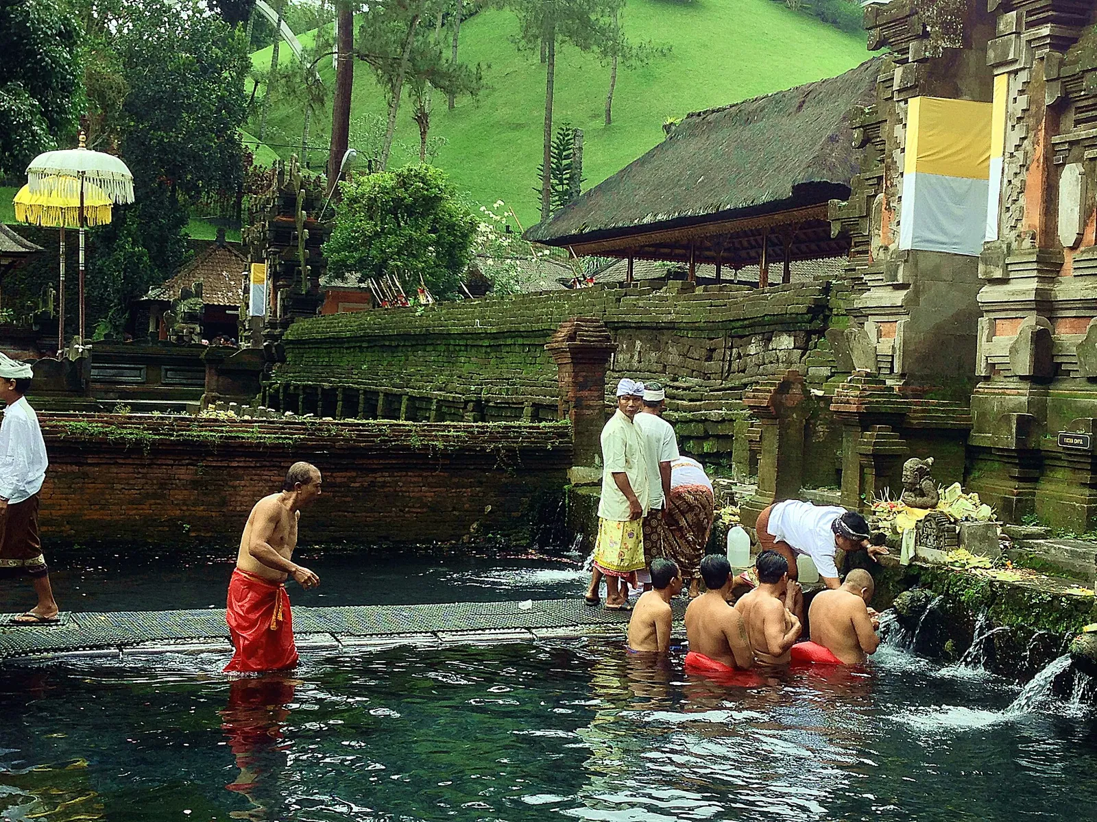 Worshippers bathing under the spouts of the purification pool at Pura Tirta Empul, Bali