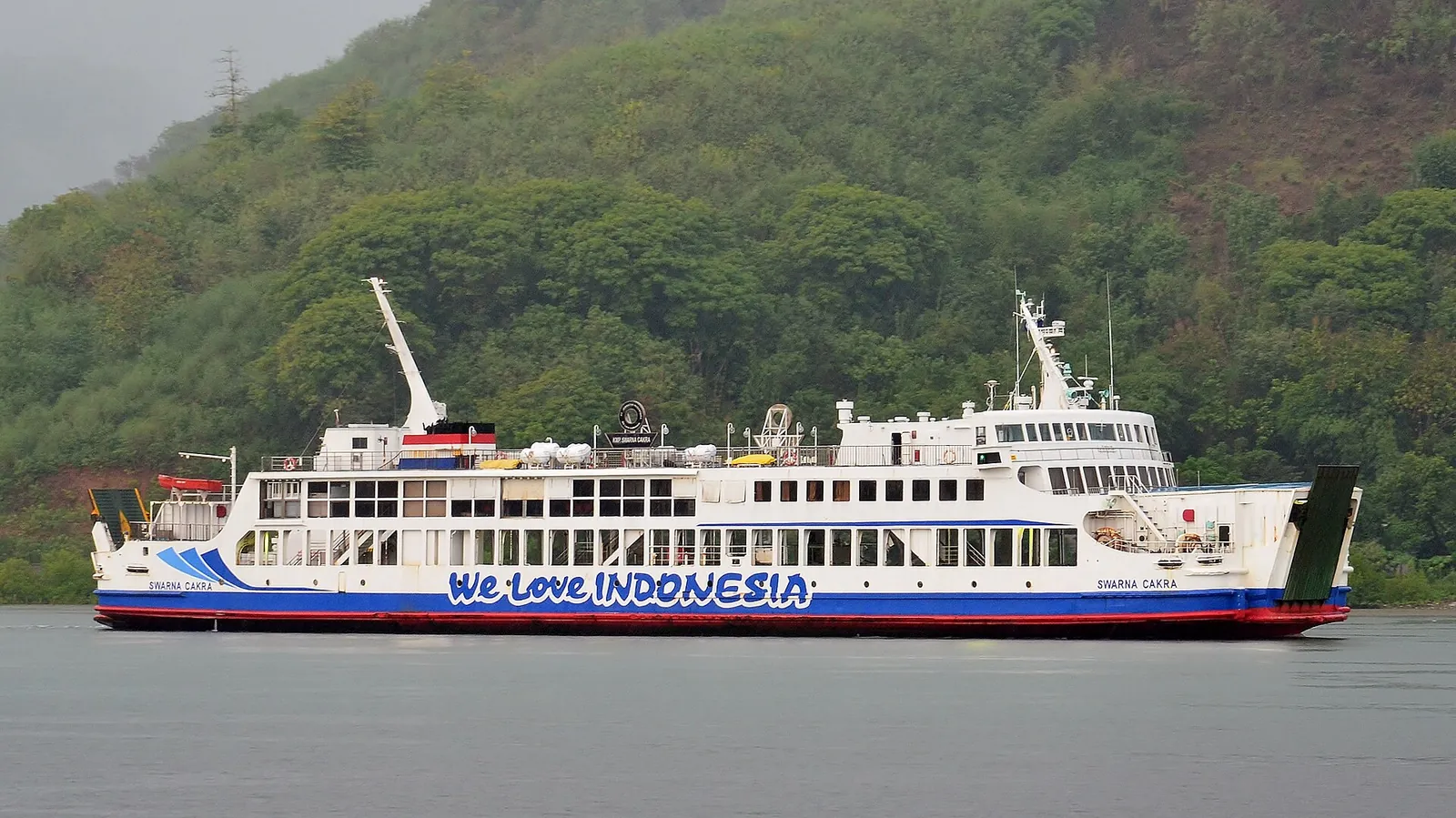 The white car ferry Swarna Cakra sailing past green hills from Lembar harbour in Lombok