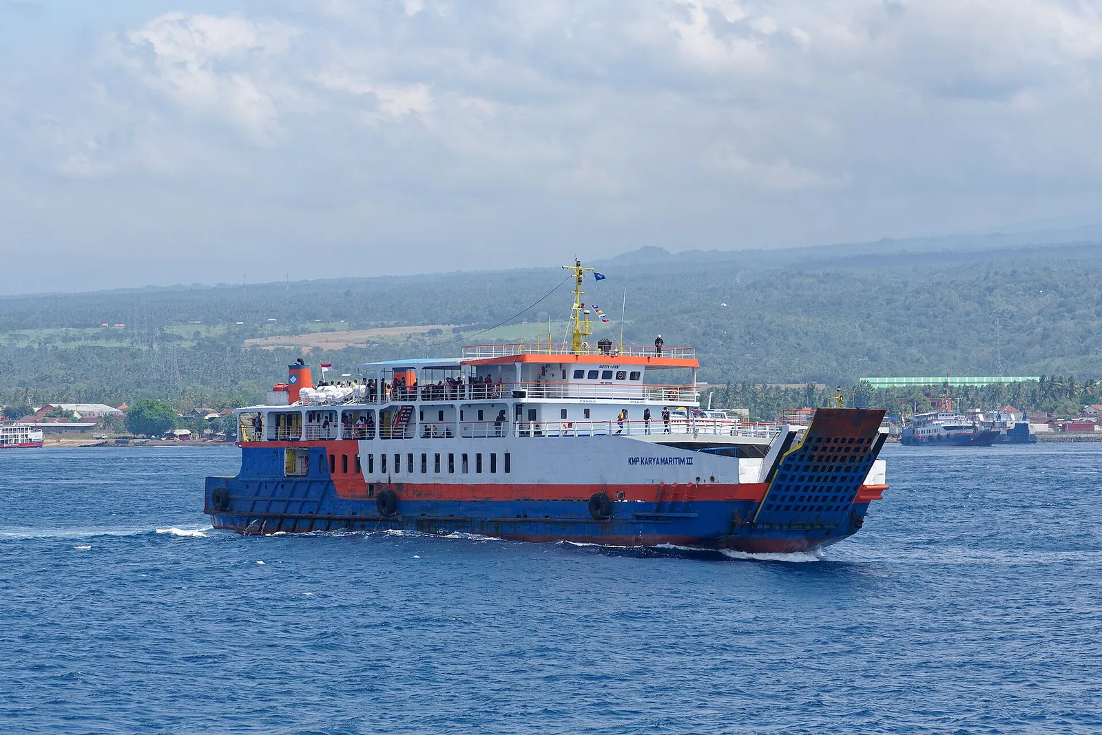 A blue-and-white car ferry crossing the Bali Strait from Ketapang in East Java towards Gilimanuk in Bali