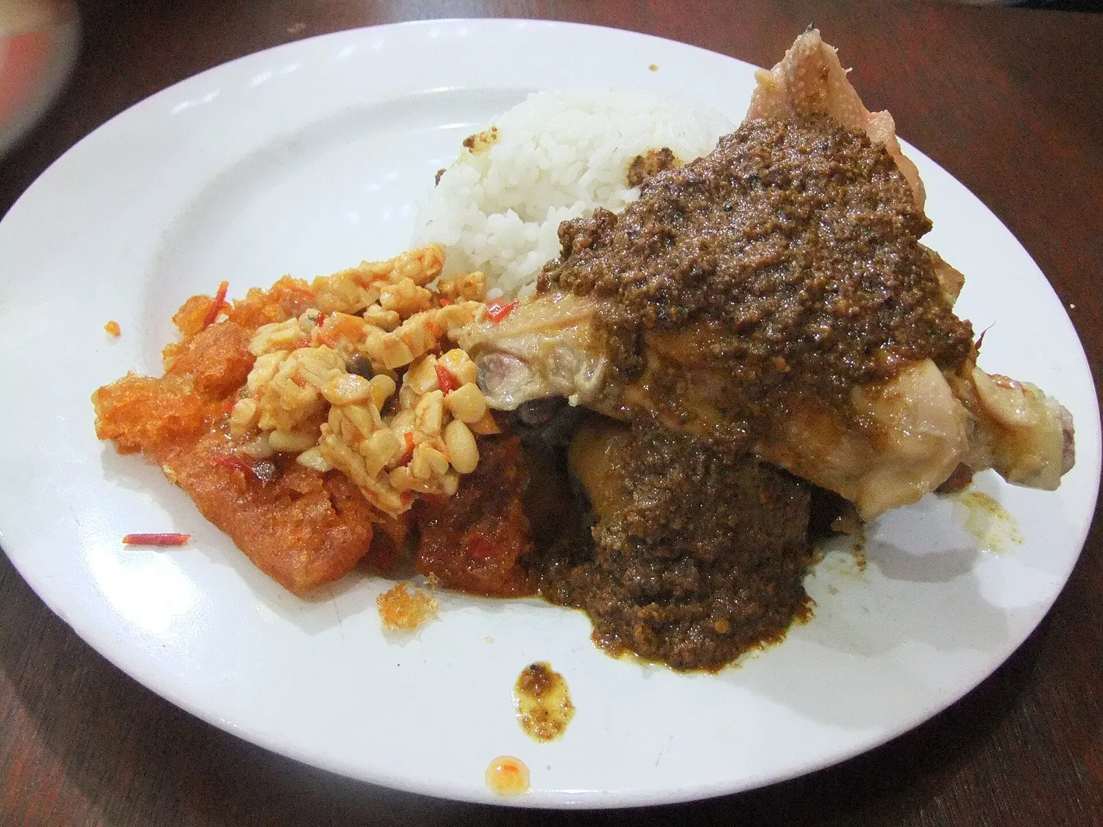 A plate of gudeg with rice, chicken, egg and spicy krecek in Wijilan, Yogyakarta