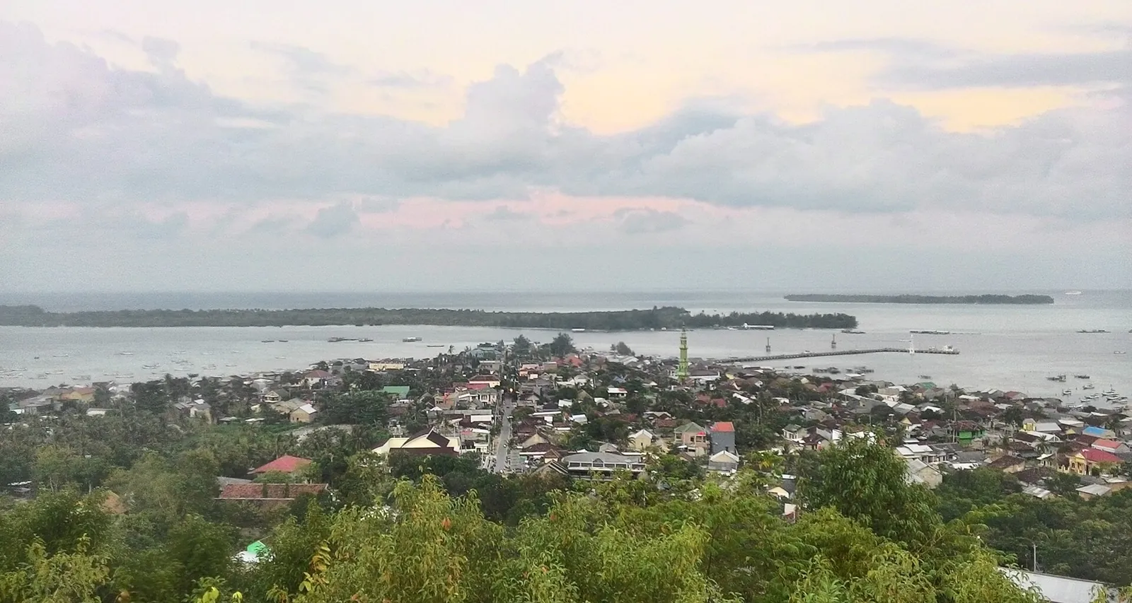 View over the rooftops of Karimunjawa town to the sea and nearby islands in the morning