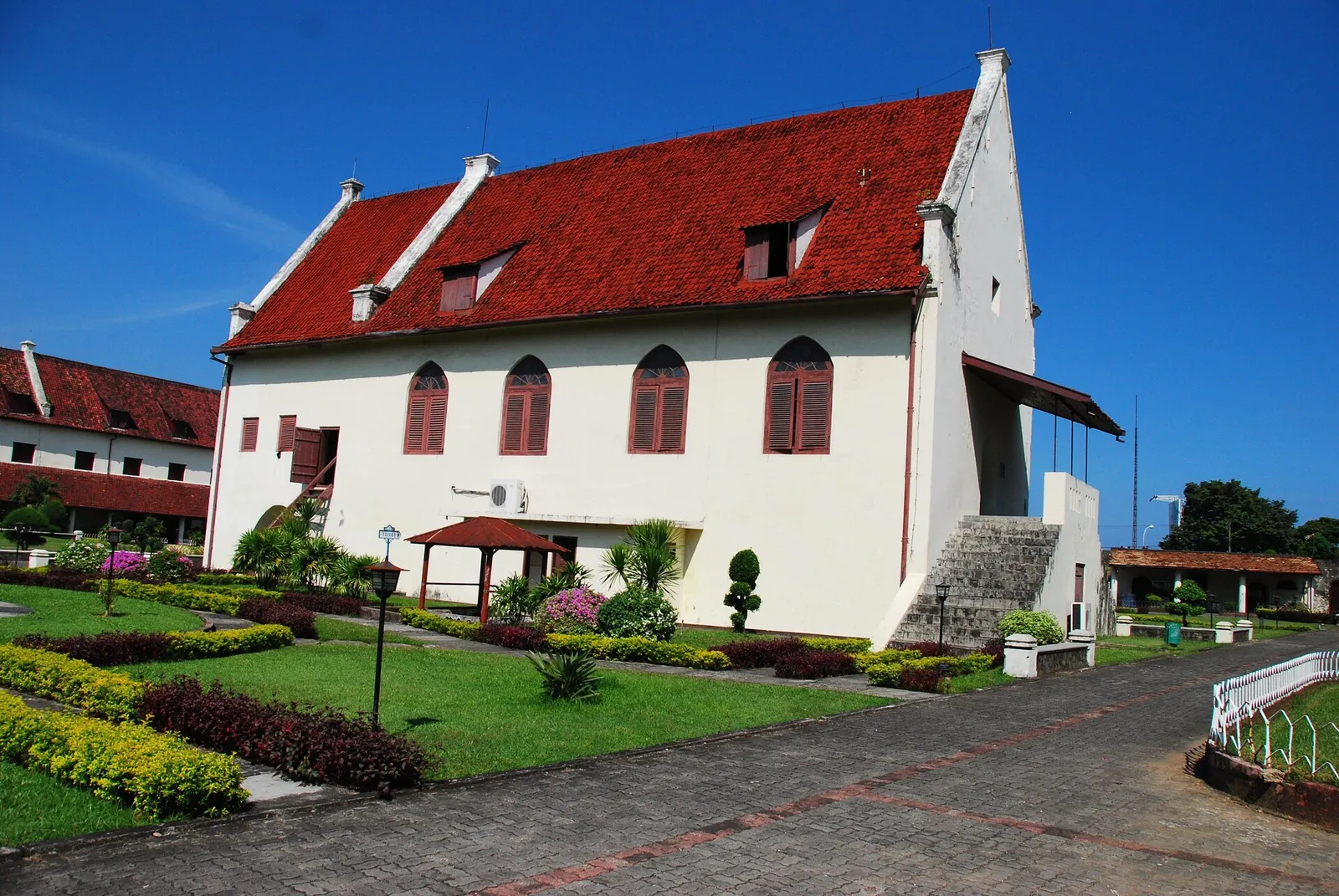 A whitewashed building with a steep red tiled roof and gabled end inside Fort Rotterdam, Makassar