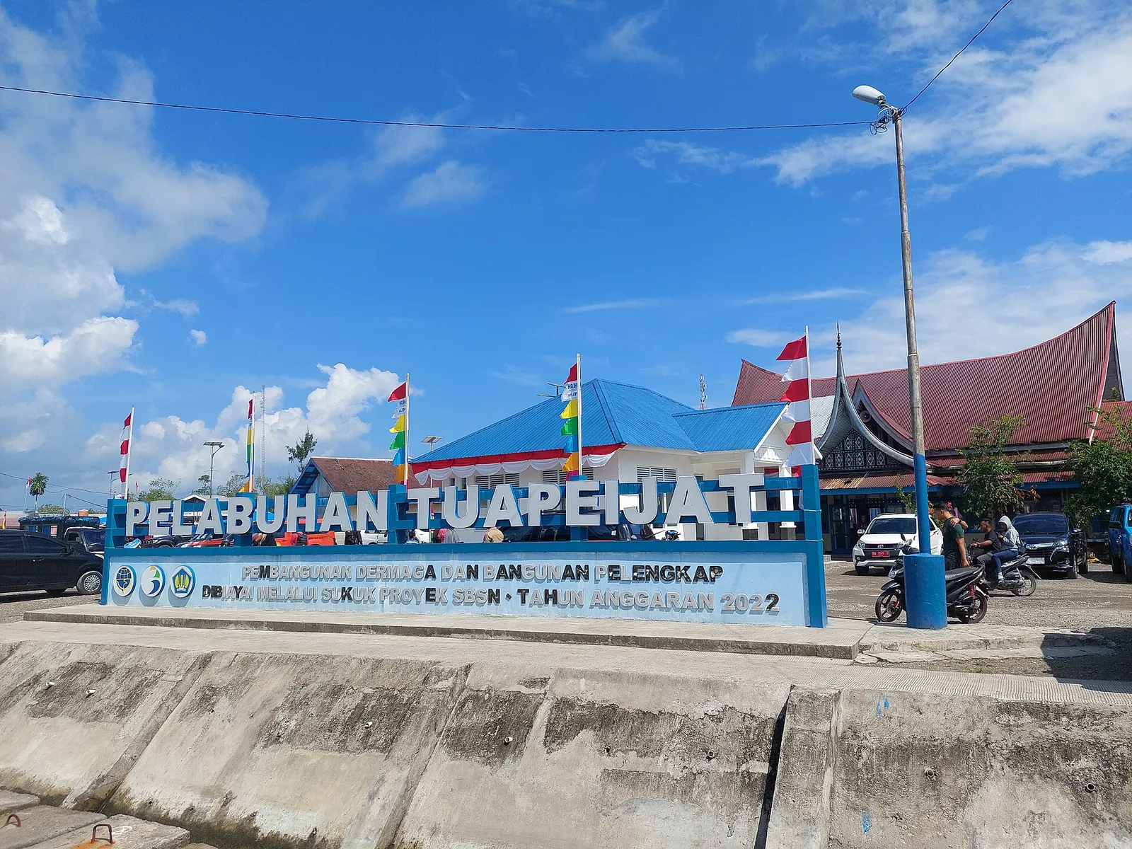 The Pelabuhan Tuapejat sign at Tuapejat harbour with the port building behind