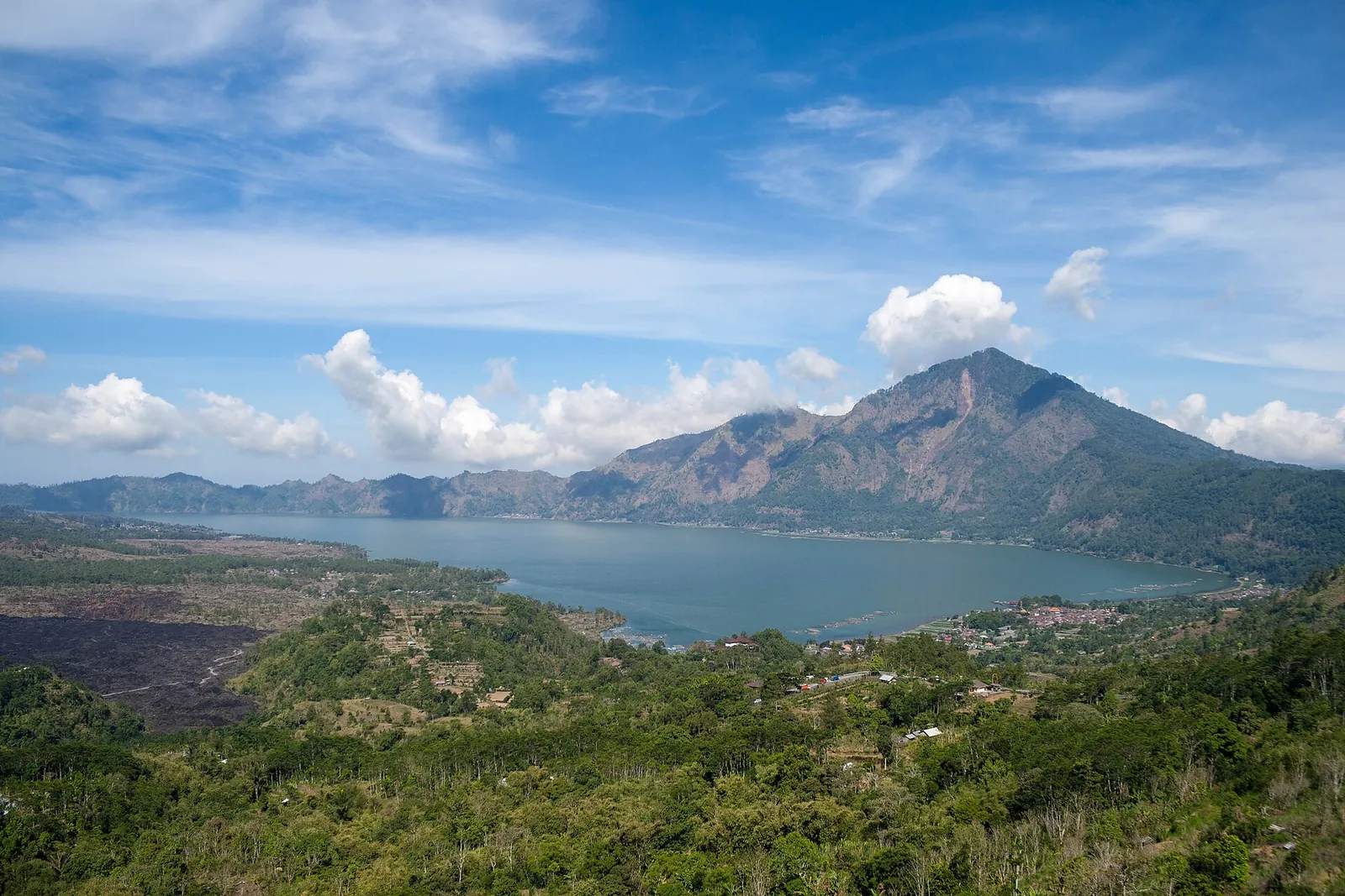 Lake Batur below the steep slopes of Mount Abang, seen from the caldera rim