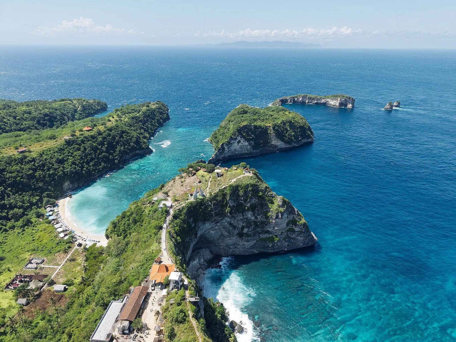 Aerial view of the Diamond Beach coastline on Nusa Penida, with cliffs, rock stacks and turquoise water