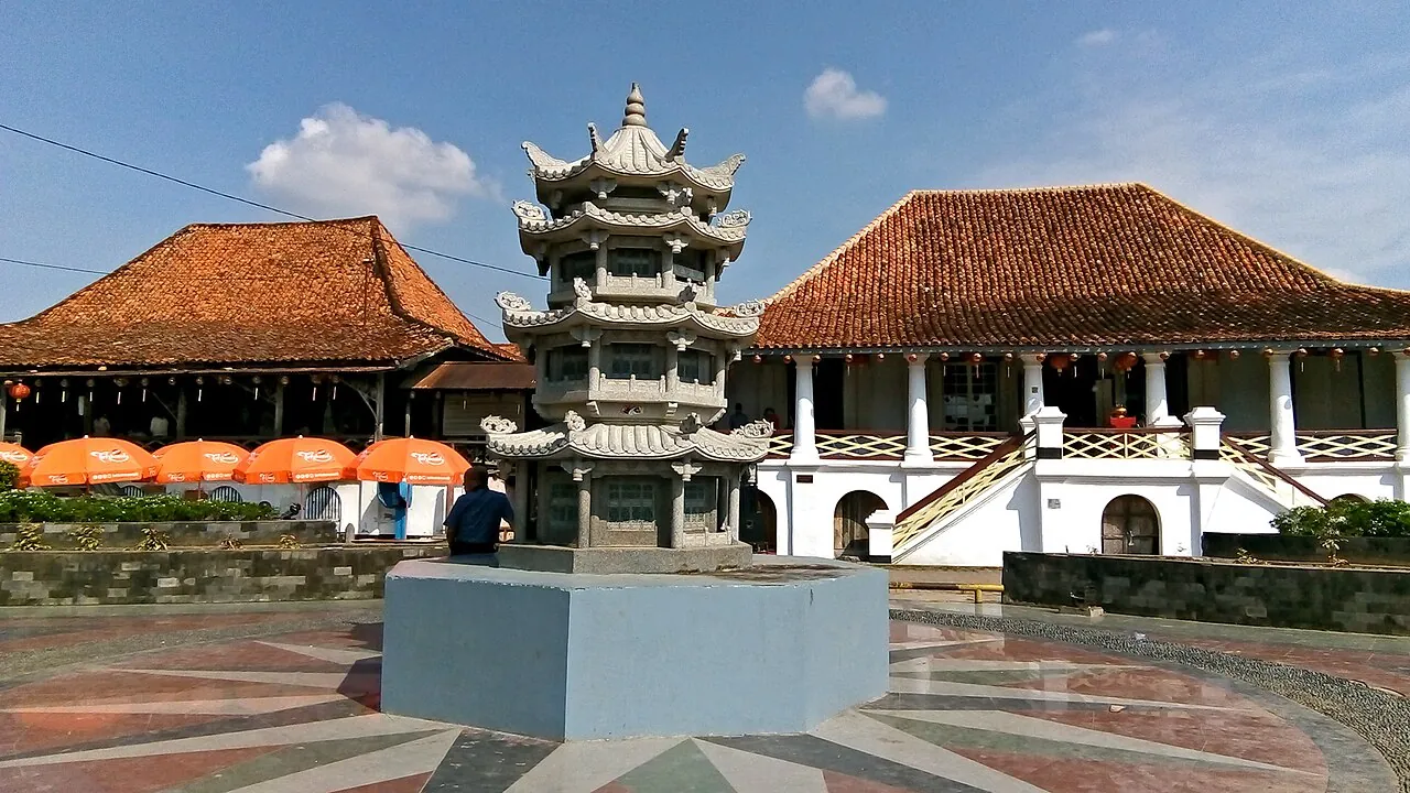 A small Chinese-style pagoda in front of the tiled-roof houses of Kampung Kapitan in Palembang