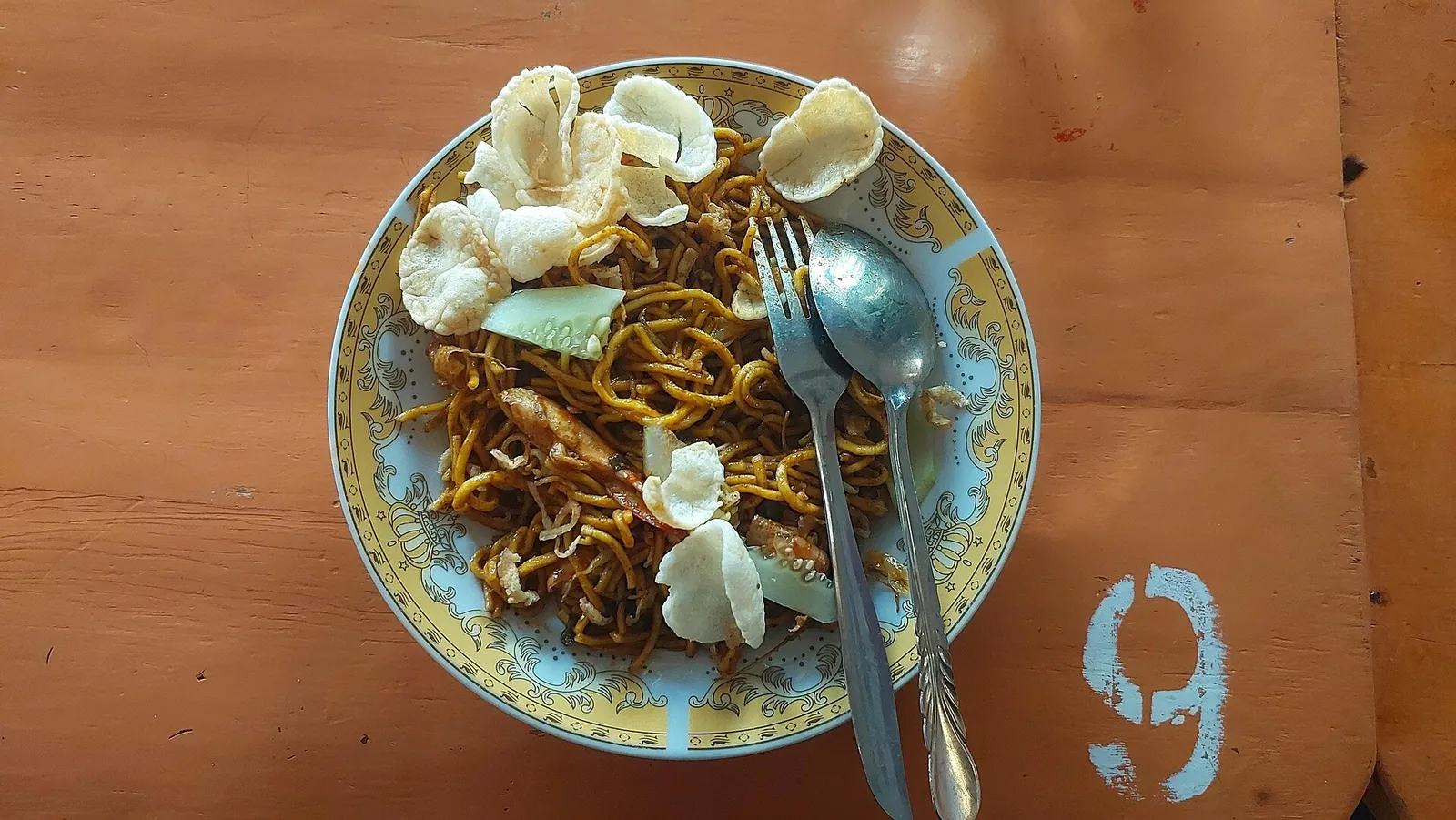 A plate of Mie Aceh noodles topped with emping crackers, served at a cafe in Sabang on Pulau Weh