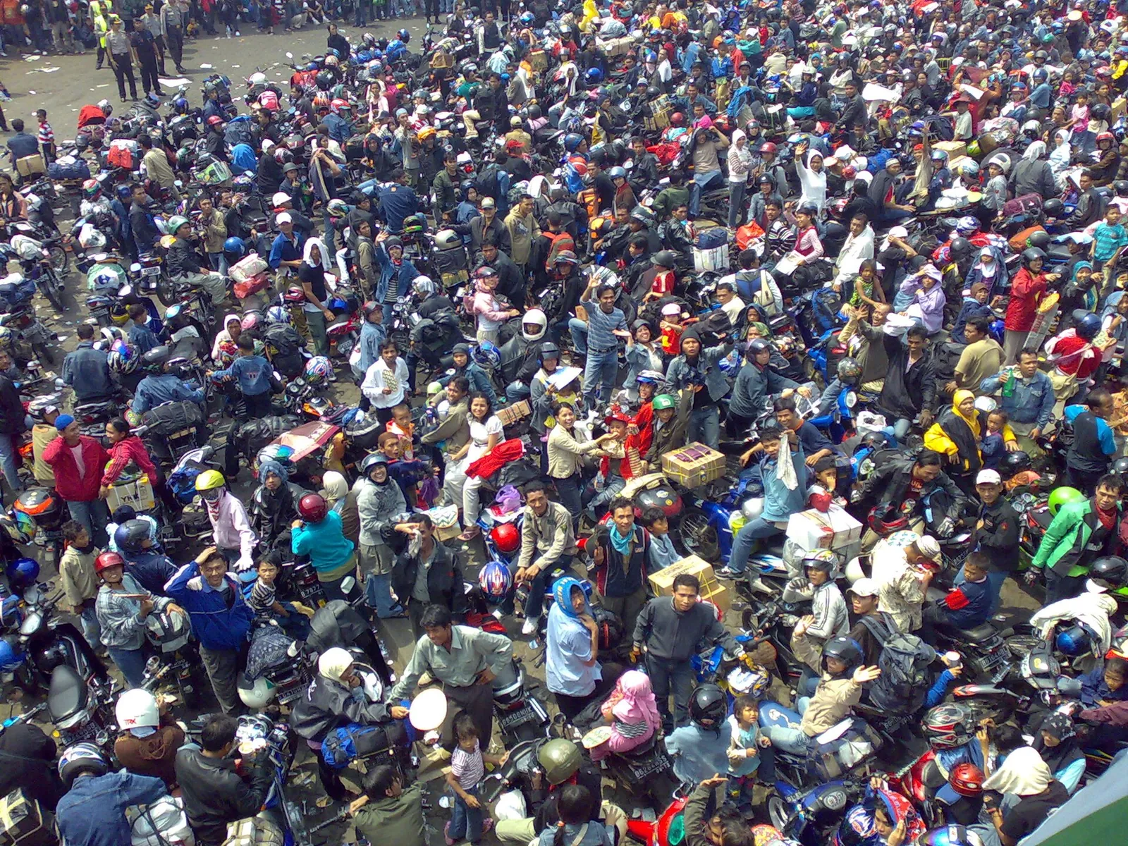 Thousands of motorcyclists and their luggage packed together waiting for a ferry