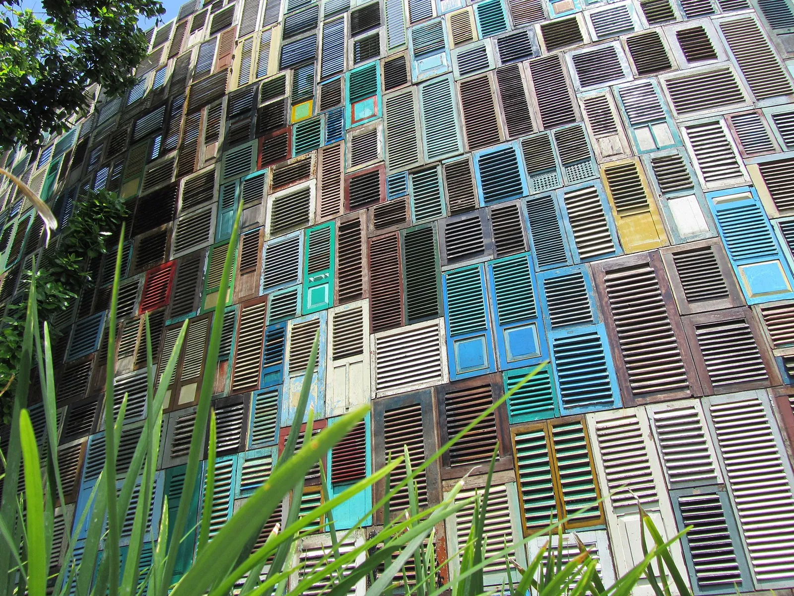 Facade made of hundreds of old painted wooden window shutters at Potato Head in Seminyak
