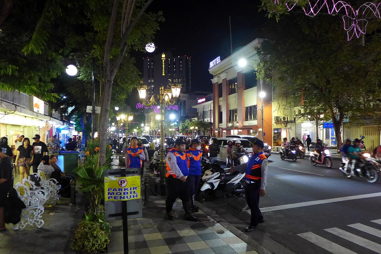 Evening crowds, street lights and heritage shopfronts along Jalan Tunjungan in Surabaya