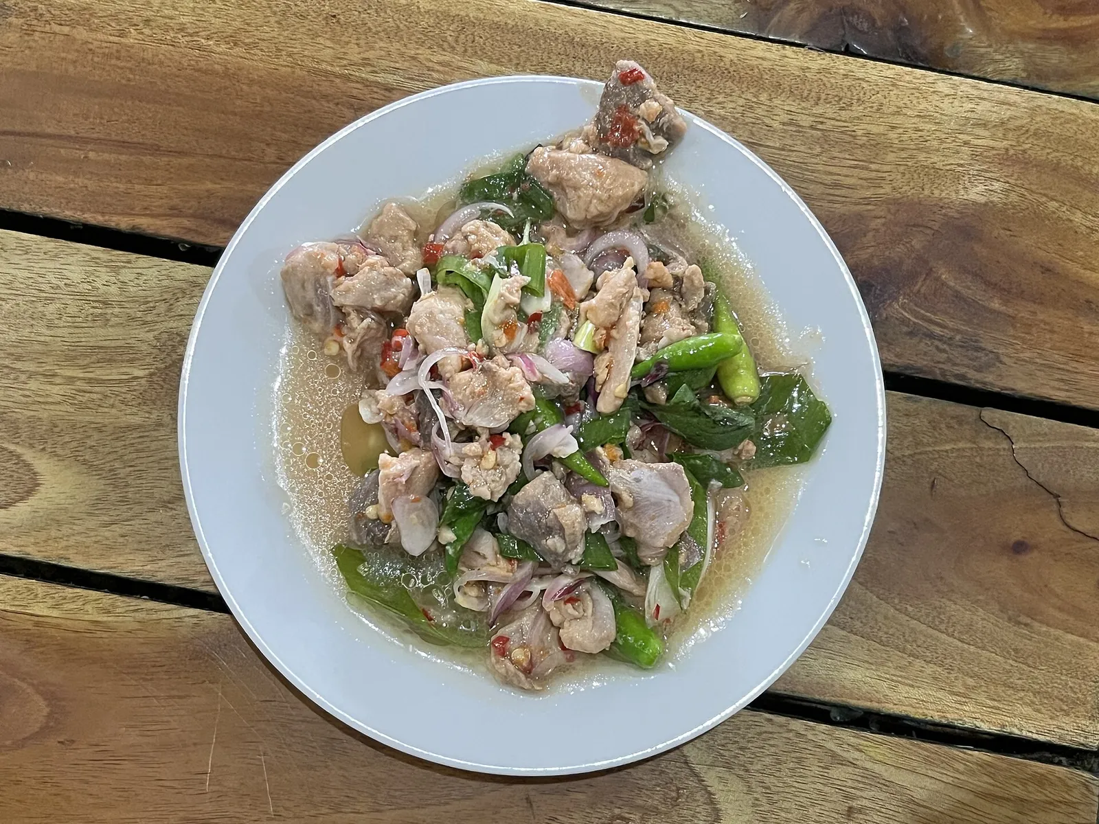 A plate of gohu ikan: cubes of raw tuna tossed with green chilli, shallot and basil in oil