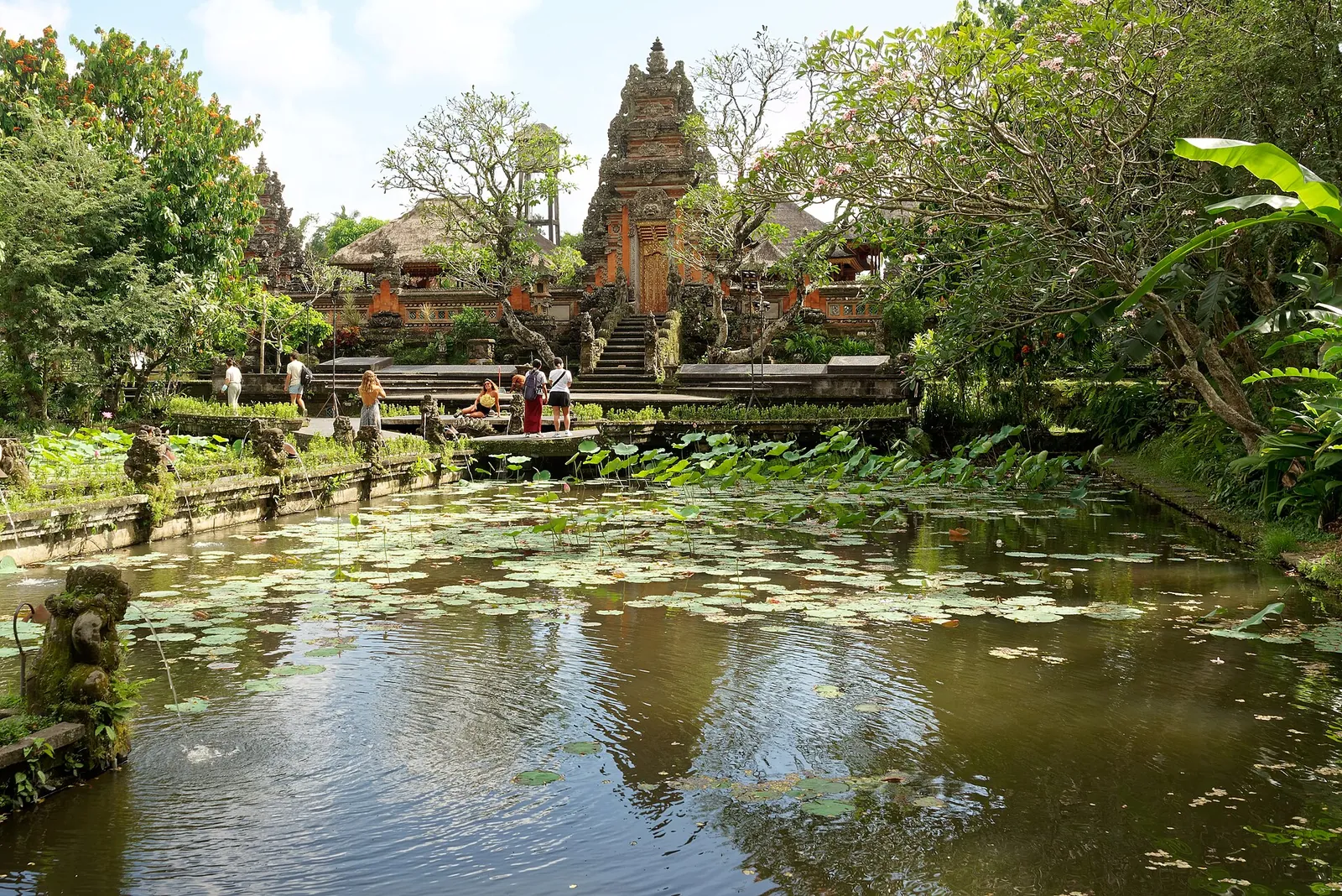 Lotus pond in front of the carved red-brick gate of Pura Taman Saraswati in central Ubud
