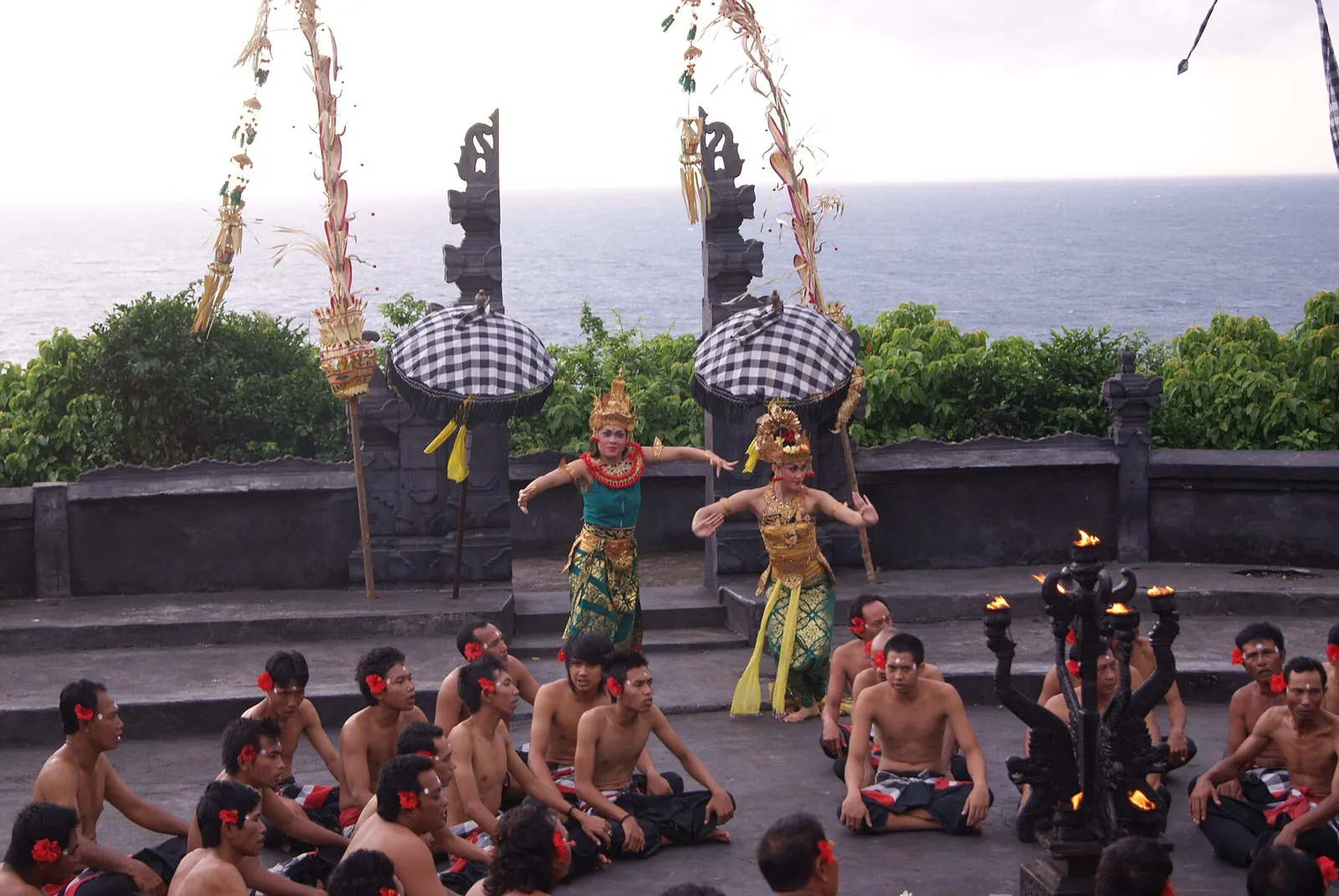 Kecak dancers in costume as Rama and Sita in front of a seated chorus at the Uluwatu clifftop stage