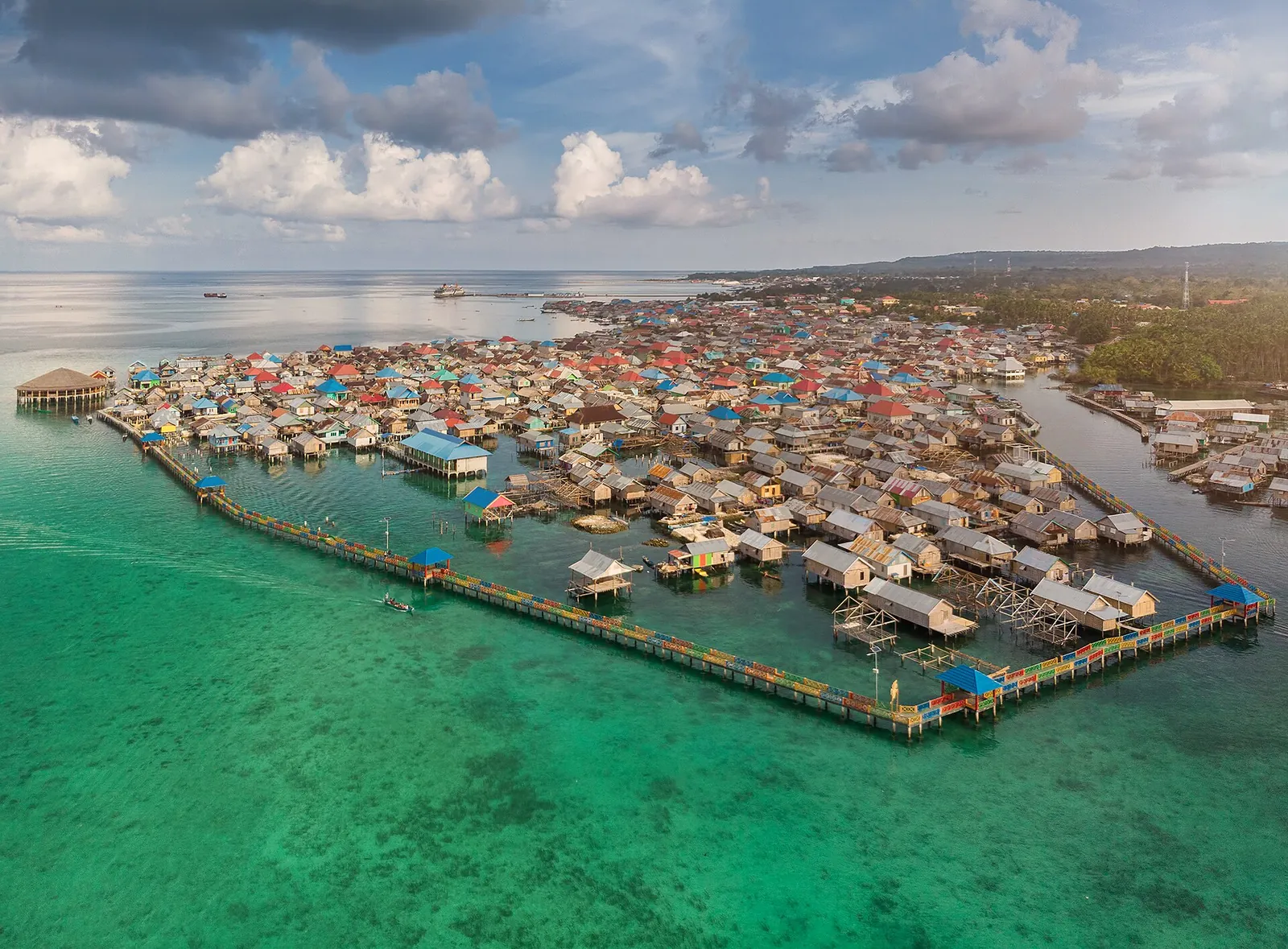 Aerial view of a Bajo stilt village over turquoise shallows on Wangi-Wangi, Wakatobi