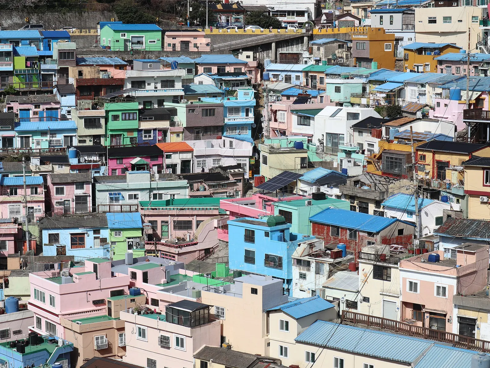 Rows of pastel-painted houses stacked up a hillside in Gamcheon Culture Village, Busan