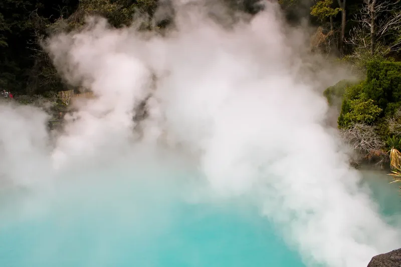 Steam rising above the turquoise water of Umi Jigoku in Beppu.