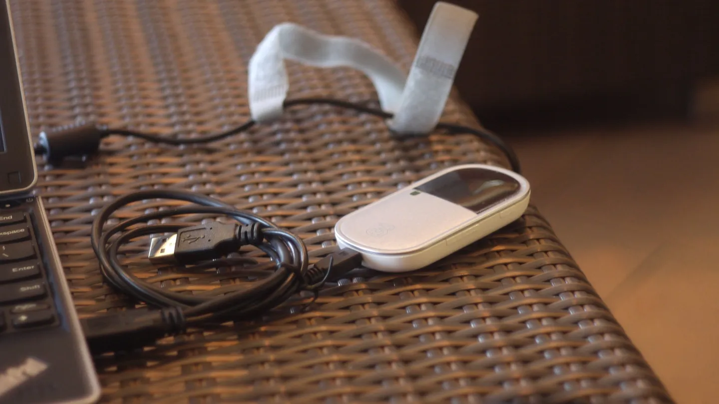 A portable pocket Wi-Fi device and cable.