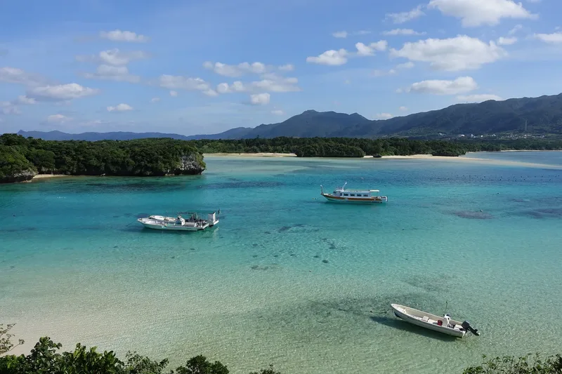 Boats on the clear and turquoise waters of Kabira Bay in Ishigaki.