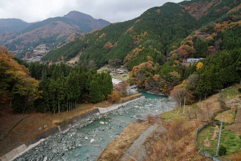 The blue river and forested mountain slopes of Iya Valley in Tokushima.