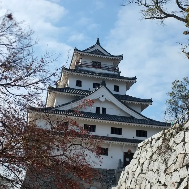 Karatsu Castle's keep viewed from below its stone walls.