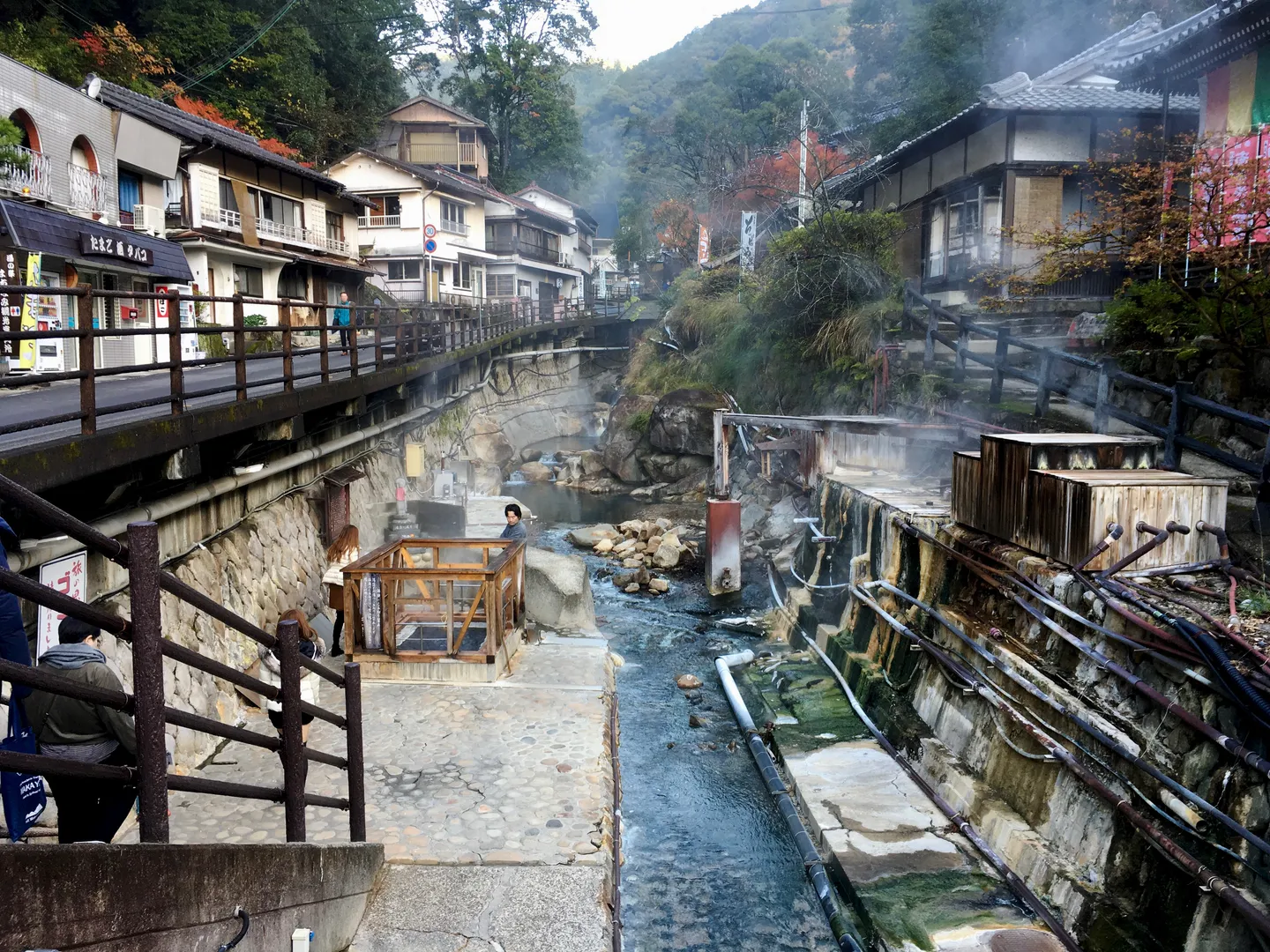 A stream and traditional buildings in Yunomine Onsen.
