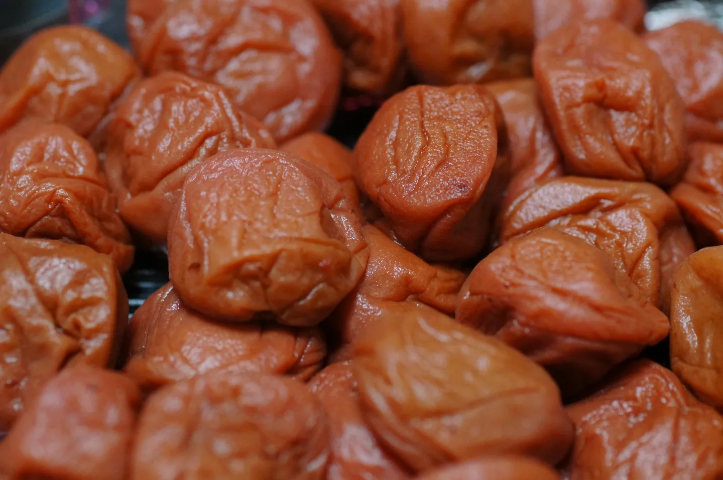 Red umeboshi preserved plums in close-up.