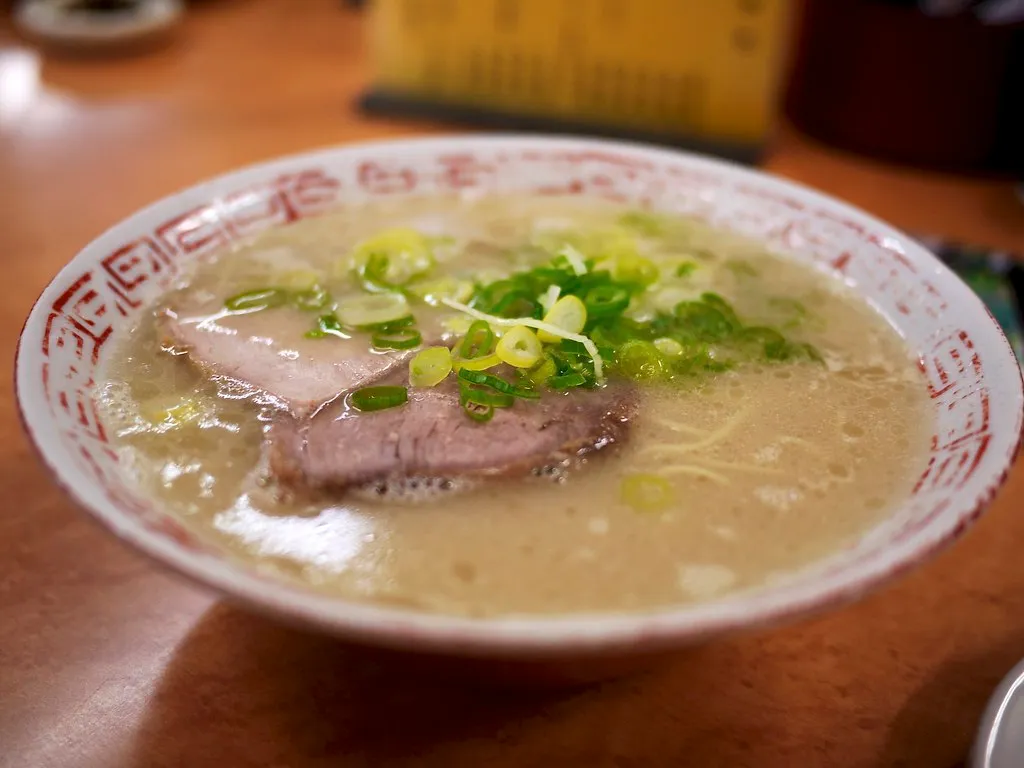 Hakata-style ramen with pork and spring onion; an illustrative food photograph.