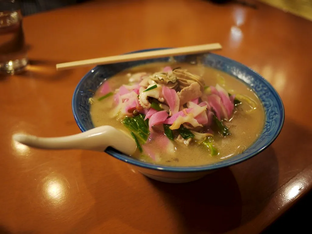 A bowl of Nagasaki champon noodles with broth and toppings.