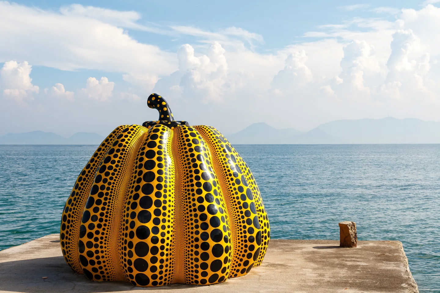 Yayoi Kusama's yellow pumpkin sculpture on Naoshima's waterfront.