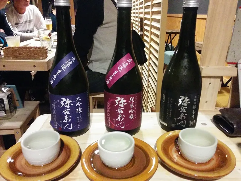 Bottles and tasting cups of Aizu sake