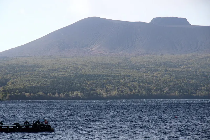 Mount Tarumae across the blue water of Lake Shikotsu.