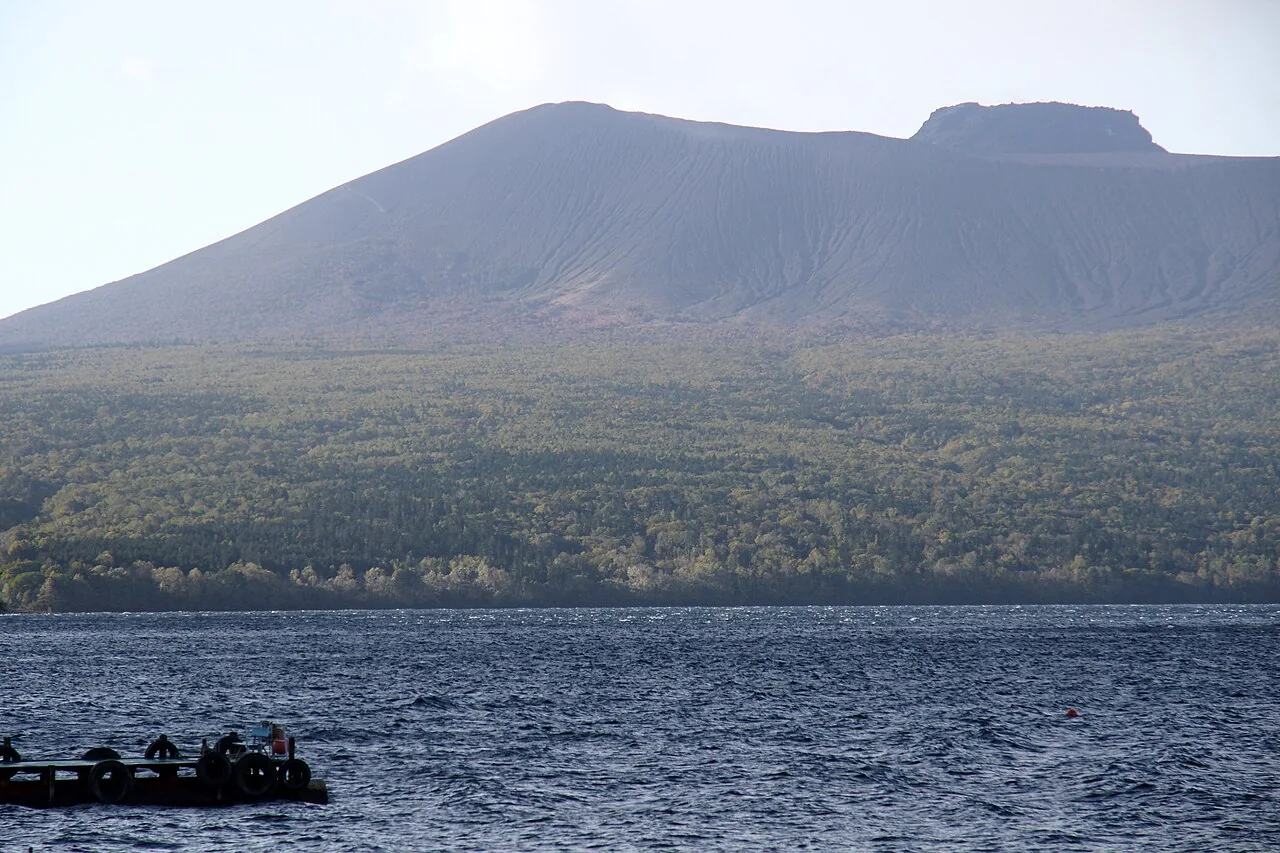Mount Tarumae across the blue water of Lake Shikotsu.