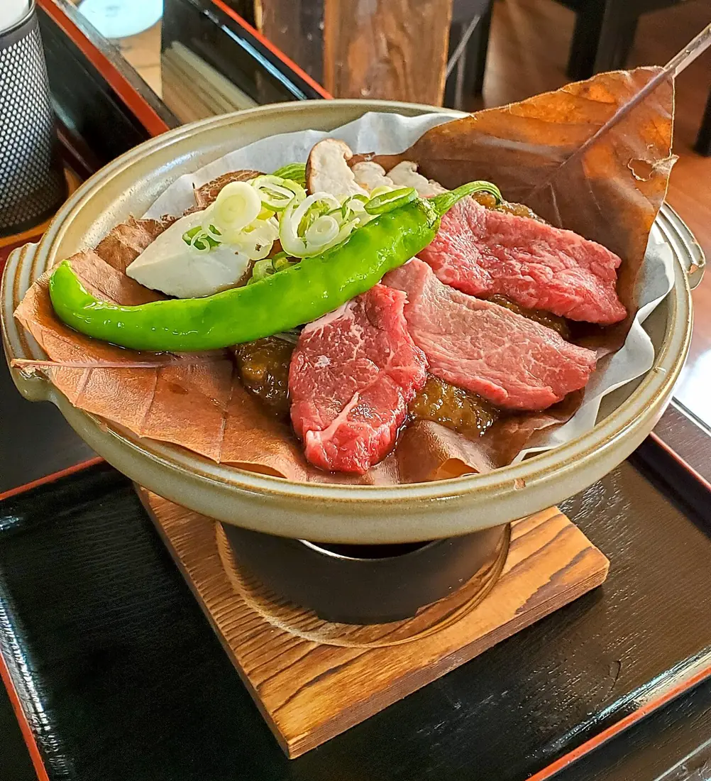 Hida beef with hoba miso on a magnolia leaf, ready for cooking.