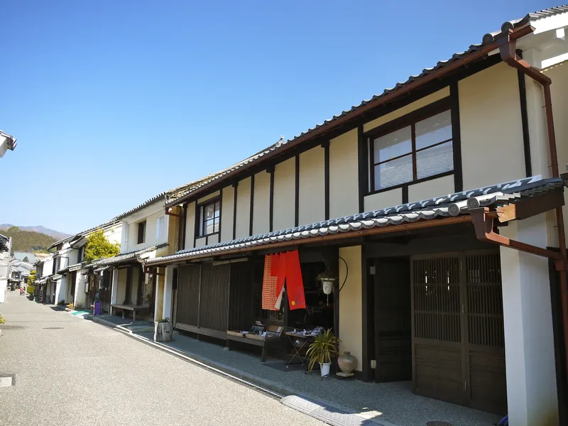 White plaster and timber facades along a historic street in Uchiko, Ehime.