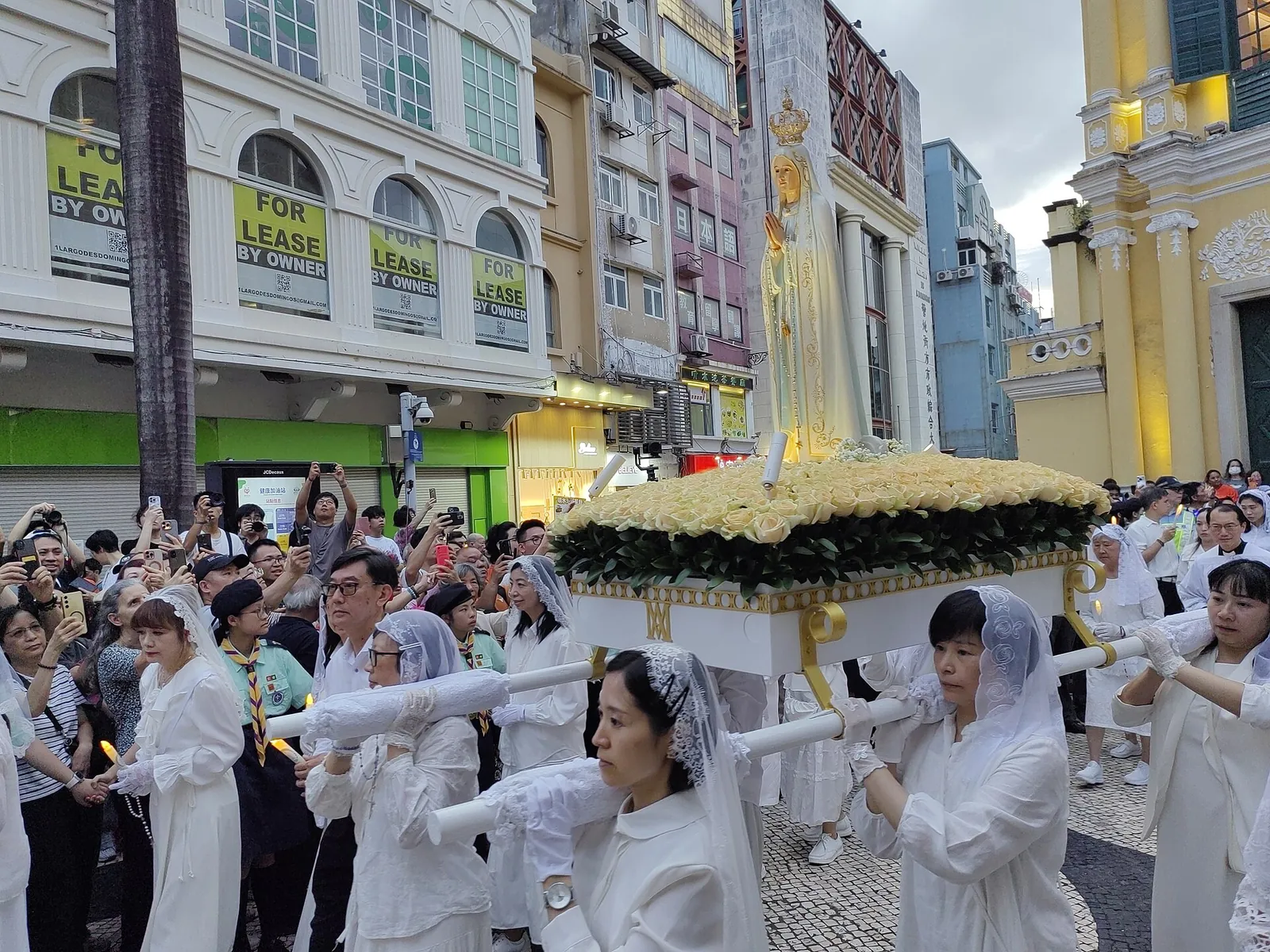 A statue of Our Lady of Fatima carried through the streets of Macau in an evening procession