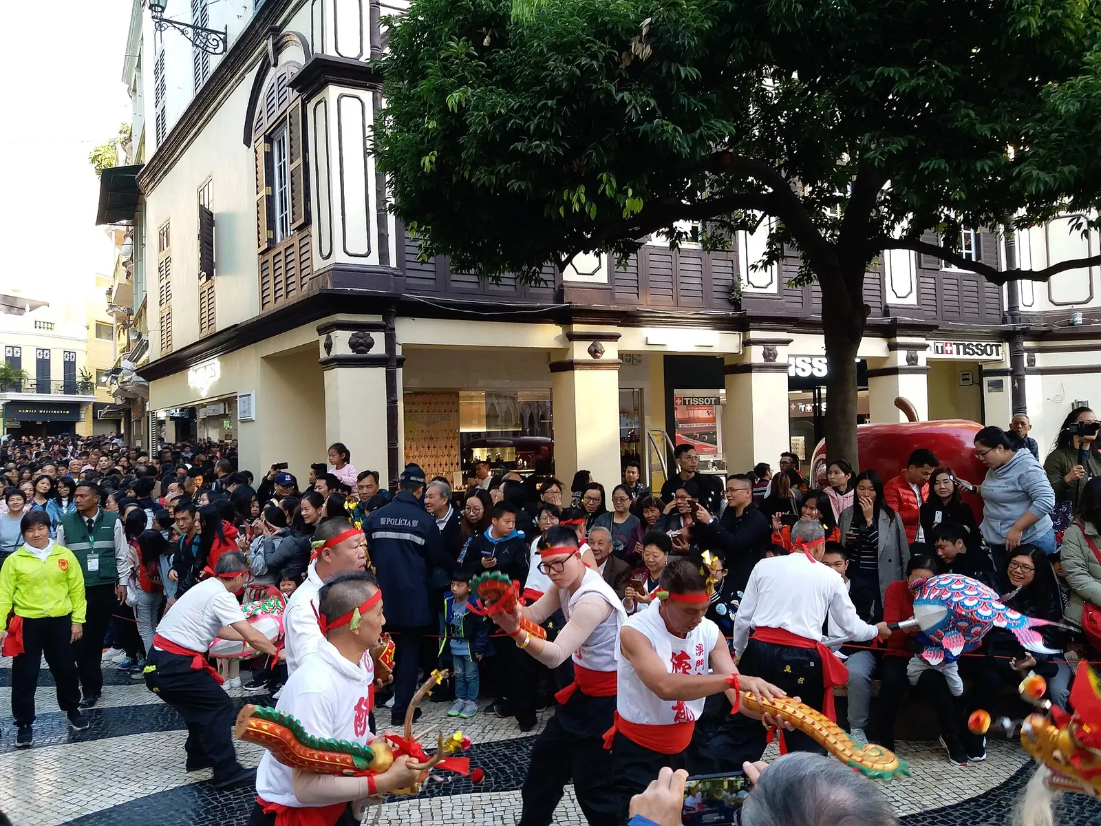 Costumed performers in a street parade in Macau's historic centre