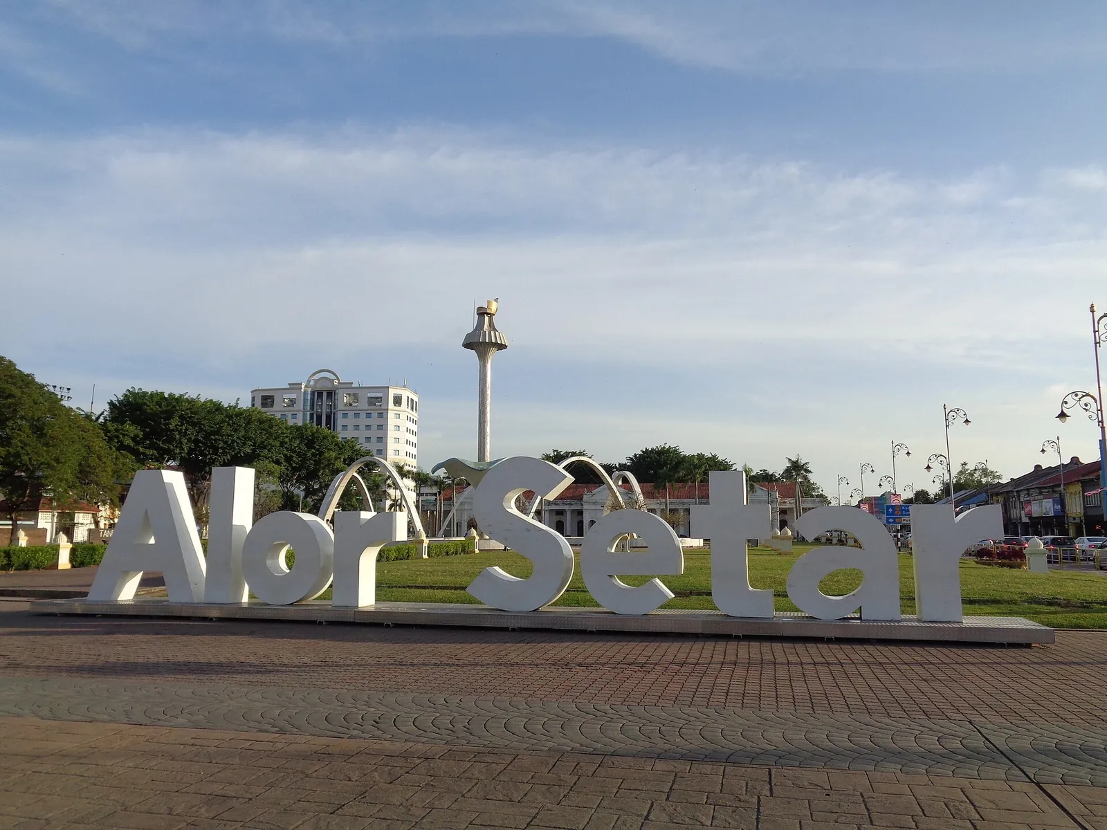 Large Alor Setar lettering in a city square under the sky