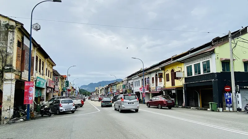 Colourful shophouses and road traffic along Jalan Loke Yew in Bentong