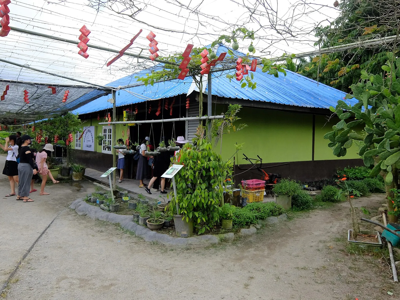 Green gallery building and visitors at Desaru Fruit Farm