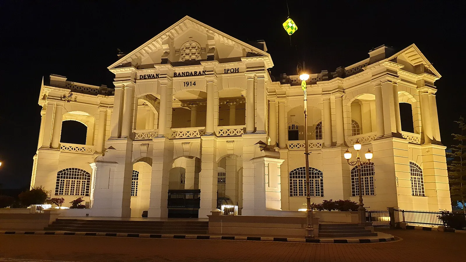 Illuminated pale facade of the historic Ipoh Town Hall at night